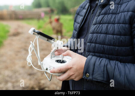 Gli uomini con le mani in mano tenendo premuto Comando remoto del drone Foto Stock