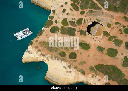 VISTA AEREA. Algar de Benagil: Una grande grotta marina fotogenica sulla costa frastagliata dell'Algarve. Lagoa, Portogallo. Foto Stock