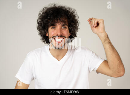 Ritratto di giovane attraente modello con faccia felice, sorriso bellissimo e divertente lo stile dei capelli. Bello millenaria l uomo nella sua 20s. Studio shot. In Persone, Foto Stock