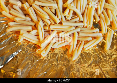 La pasta italiana Le casarecce su uno sfondo colorato , breve e torsione forma di pasta Foto Stock