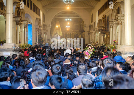 La folla si raduna per vedere come la Virgen del Carmen è portato fuori in processione per le strade di Paucartambo durante il suo Festival, Perù Foto Stock