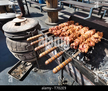 La carne cruda è preparato su spiedini grigliate barbecue a carbone. Grill a carbone e fiamma, picnic, cibo di strada. Foto Stock