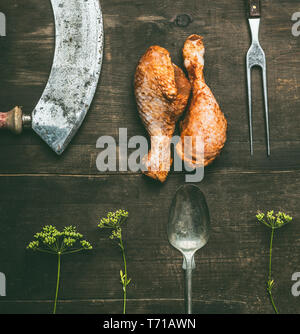 Barbecue crudo marinato coscia di pollo con erbe fresche e utensili da cucina in legno rustico sfondo, vista dall'alto. Preparazione del grill Foto Stock