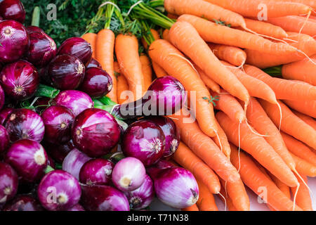Carote e viola la cipolla rossa sul mercato degli agricoltori Foto Stock