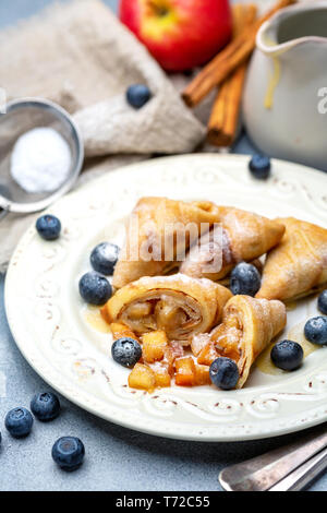 Crepes con ripieno di mele, mirtillo e salsa di caramello. Foto Stock