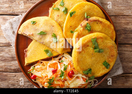 Tradizione latina American pupusas servita con curtido closeup su una piastra sul tavolo. Parte superiore orizzontale vista da sopra Foto Stock