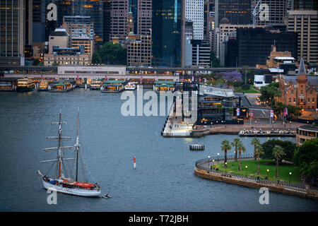 Barca a vela e Circular Quay principale terminale dei traghetti nel centro cittadino di Sydney New South Wales AUSTRALIA Foto Stock