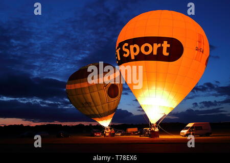 Due i palloni ad aria calda illuminata da loro bruciatori a Abingdon, Regno Unito Foto Stock