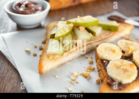 Dolce gustoso pane tostato con frutti sul tavolo di legno Foto Stock