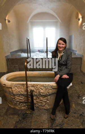 Bormio Terme, stabilimento " Bagni Nuovi': il direttore Cristina Confortola, siede su una vasca di marmo dove ci si pu ò immergere in acqua fredda pe Foto Stock