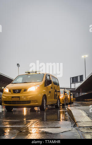 NEW YORK, Stati Uniti d'America - 22 febbraio 2018: New York Taxi giallo coda sul giorno di pioggia all'Aeroporto JFK Foto Stock