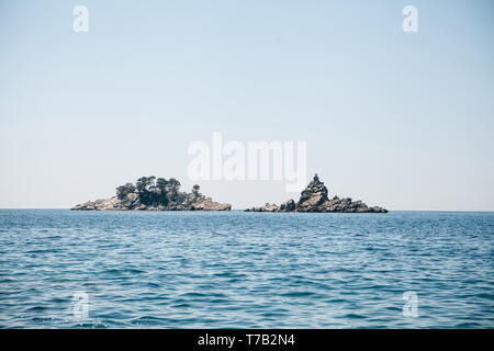 Vista della bellissima isolotti Katic e Sveta Nedjelja con la chiesa ortodossa vicino a Petrovac in Montenegro nel comune di Budva. Foto Stock