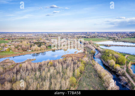 Poudre fiume che scorre verso Fort Collins Colorado attraverso colline, la primavera vista aerea Foto Stock