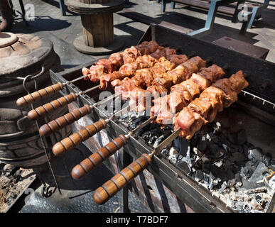 La carne cruda è preparato su spiedini grigliate barbecue a carbone. Grill a carbone e fiamma, picnic, cibo di strada. Foto Stock