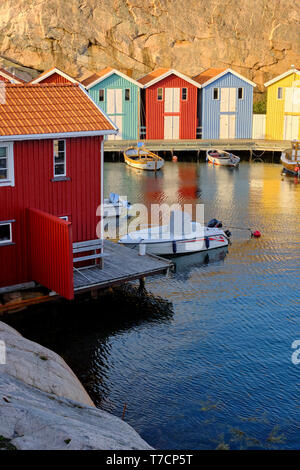 In maniera colorata di legno verniciato di pesca tradizionali capanne in barca / cabine in Smogen sulla costa di Bohuslan in Vastra Gotaland Svezia Foto Stock