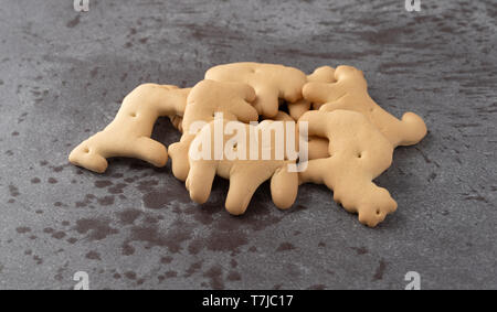 Vista laterale di Elefanti, ippopotami, bufali, ovini e cammello animale sagomato cracker su sfondo grigio illuminato con luce naturale. Foto Stock