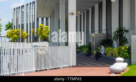 Uomo seduto su mobili da esterno in occasione del cinquantesimo piano sky garden piattaforma di visualizzazione in Pinnacle@Duxton complesso di appartamenti e Singapore. Foto Stock