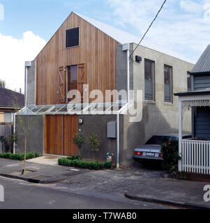 Rivestimento in legno su una vista frontale in elevazione di una moderna casa grigio Foto Stock