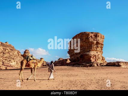 Bedouin camminando con il suo cammello, Wadi Rum, Governatorato di Aqaba, Giordania, Medio Oriente Foto Stock