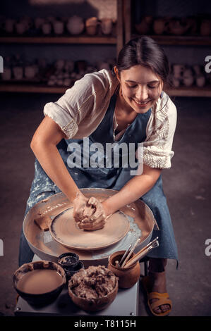 Elegante rendendo artigiano di ceramica sulla ruota. Prodotti fatti a mano. Foto Stock