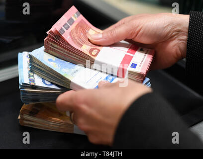 Garmisch Partenkirchen, Germania. Il 10 maggio, 2019. Illustrazione - banconote sono depositati in pacchi allo sportello di una filiale di banca. Credito: Angelika Warmuth/dpa/Alamy Live News Foto Stock