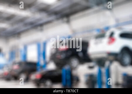 Scena sfocata Automobili Riparazione di sollevamento controllare e risolvere un problema in garage Foto Stock