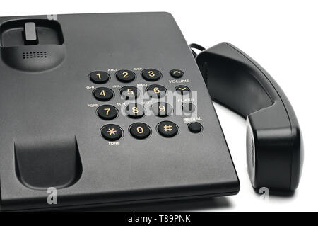 Classico telefono cablato utilizzati a casa e negli uffici su un isolato bianco sfondo.Sollevare il ricevitore del telefono Foto Stock