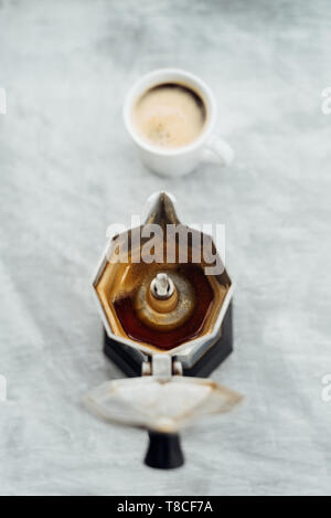 Svuotare moka pot con caffe' macinato di fresco e full cup su sfondo grigio Foto Stock