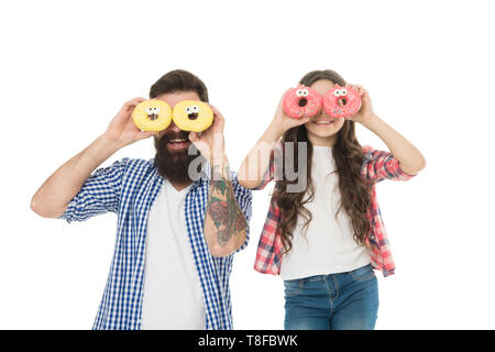 La divina ciambella classe di cottura. Uomo Barbuto e bambina bambino sorridente con ciambelle fresche dopo la cottura. La famiglia felice godendo di ciambelle smaltate secondo la ricetta di cottura. La cottura il migliore dessert. Foto Stock