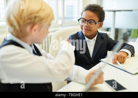 Due ragazzi multiculturale come business del contratto del partner con handshake Foto Stock