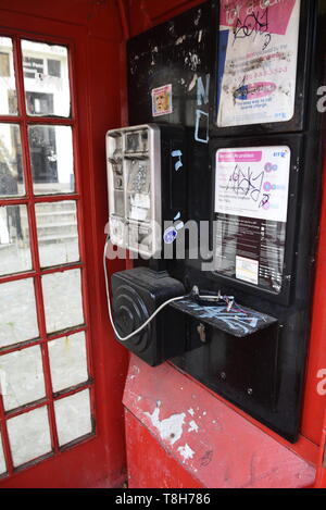 Tradizionale in rosso London telefono scatola che è stato soggetto ad atti vandalici, Londra. Foto Stock