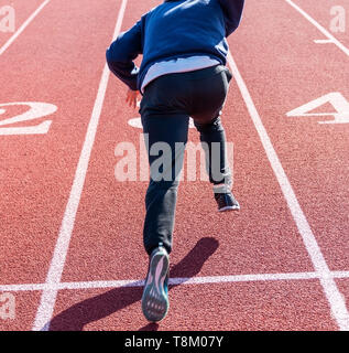 Un liceo sprinter è mettere in pratica la sua esecuzione inizia su una via a via e la pratica sul campo. Foto Stock