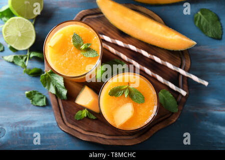 Bicchieri di gustoso frullato di melone sul tavolo Foto Stock