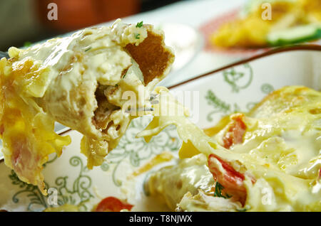 Crema di Pollo Pepperjack Enchiladas, caricato con enchilada salsa di panna acida Foto Stock