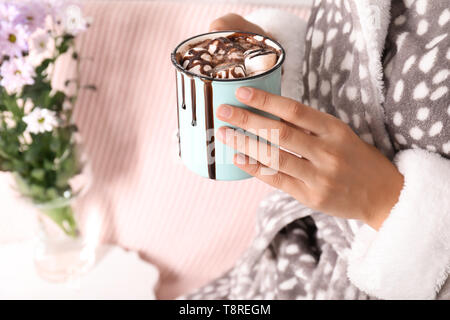 Donna che mantiene metallo tazza di cioccolata calda con marshmallows, primo piano Foto Stock
