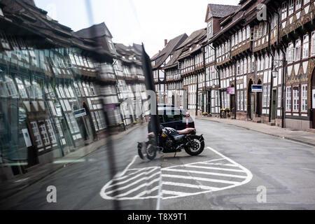 Einbeck, Germania. 14 Maggio, 2019. Tipiche case a graticcio sono riflesse in un finestra di auto in Tiedexer Straße. Al fine di rafforzare la città come un patrimonio culturale e il turismo la posizione, la cosiddetta Magistrale der Baukultur è di essere sviluppato come una strada di collegamento. Il 15.05.2019 il parlamento del Land Bassa Sassonia discuterà la costruzione di strada contributi. Credito: Swen Pförtner/dpa/Alamy Live News Foto Stock