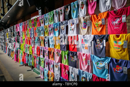 Raccolta di estate colorata t-shirt con divertenti stampe schermo venduto al negozio di souvenir a Siviglia in Spagna. Foto Stock