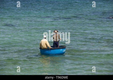 Pescatore vietnamita nel suo canestro galleggiante, Vinh Hy, Vietnam Asia Foto Stock