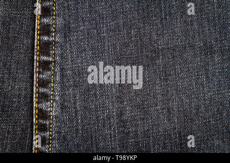 Jeans nero texture. Jeans Denim Tessuto sfondo con una cucitura. Foto Stock