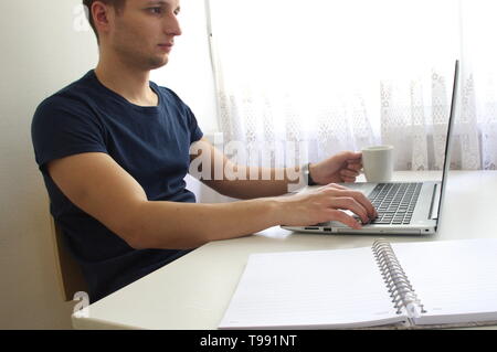 Ritratto di giovane uomo con laptop Foto Stock