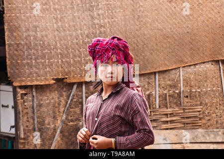 Una giovane donna birmano di Shan persone che indossano il tradizionale copricapo. Myanmar, dicembre 2011. Foto Stock