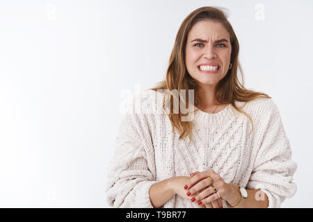 Donna sensazione scomoda intensa sensazione problemi facendo un enorme errore smorfie preoccupante ruga naso denti di aggraffaggio scendere colpevole, nervosamente Foto Stock