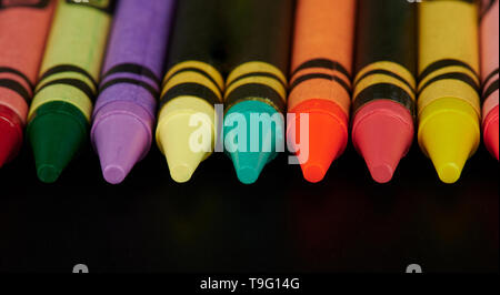Close up di matite colorate su sfondo nero Foto Stock
