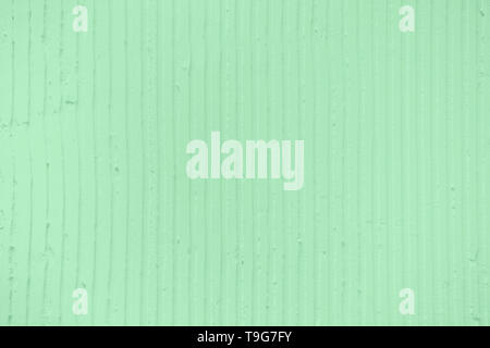 Primo piano della parete con un decorativetrendy colorato intonaco di menta linee verticali e strisce. Textured parete in cemento con una texture o dello sfondo. R Foto Stock