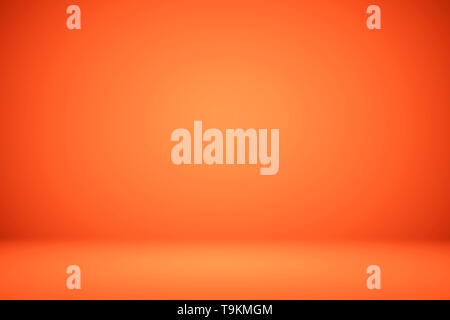 Arancione vuota studio room, usata come sfondo per visualizzare i vostri prodotti. Foto Stock