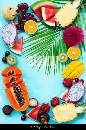 Assortimento di tropicale di frutti esotici. Sfondo blu. Copia dello spazio. Vista dall'alto. Foto Stock