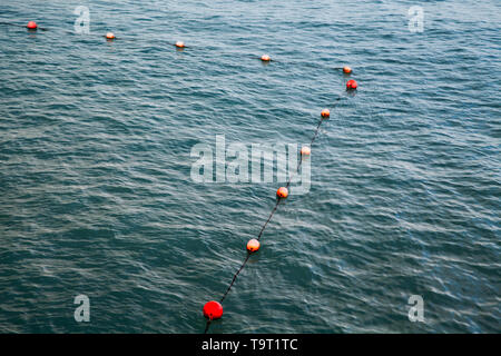 Angolo di swimming area contrassegnata in rosso e arancione sfere flottante sulla fune. Alessandria, Egitto Foto Stock