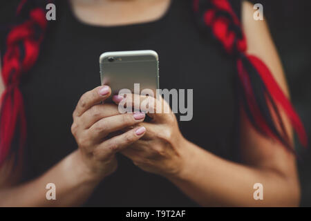 Modello femminile possiede smartphone Close-up. Tecnologie contemporanee. Foto Stock