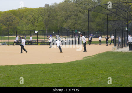 Ebrea ortodossa ragazzi giocare a baseball a Prospect Park indossando le loro uniformi riconoscibile di pantaloni neri e camicie bianche. Brooklyn, New York. Foto Stock