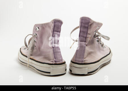 Una coppia di vecchi rosa basketball sneakers isolati su sfondo bianco. Foto Stock